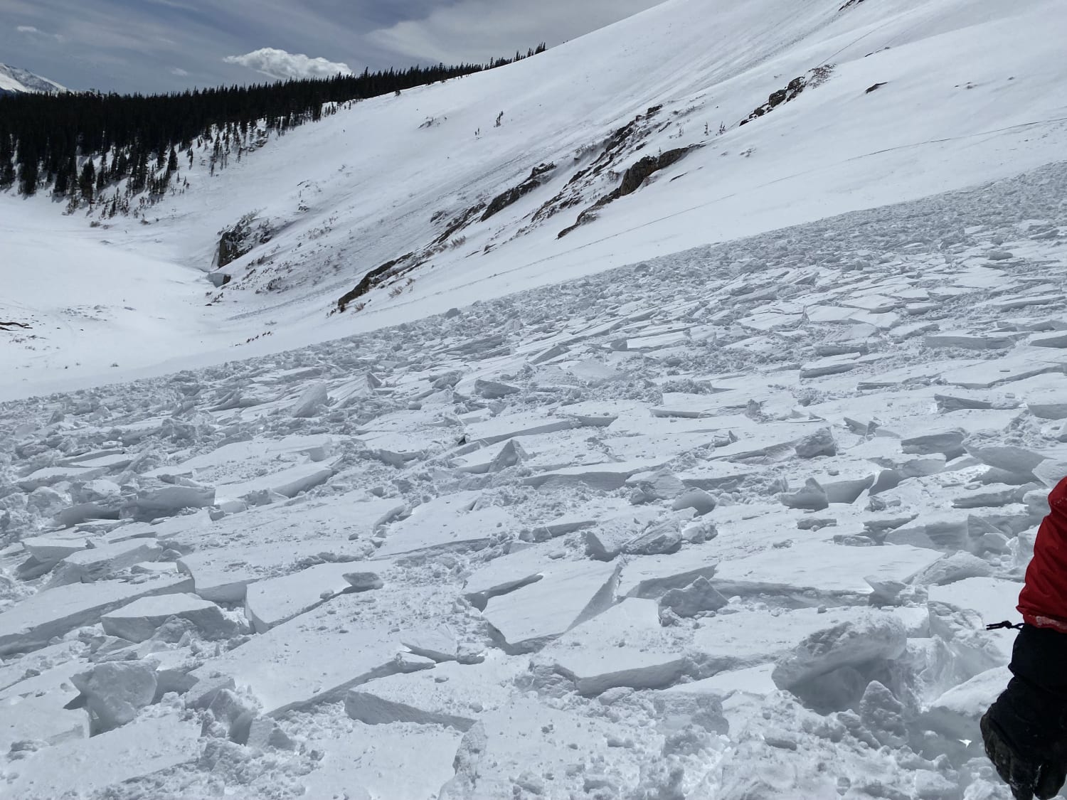 Looking down a slope of chunky avalanche debris. 