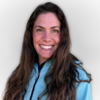 Jess Chencinski, Program Assistant at CAIC, smiling and wearing a teal jacket against a light grey background.